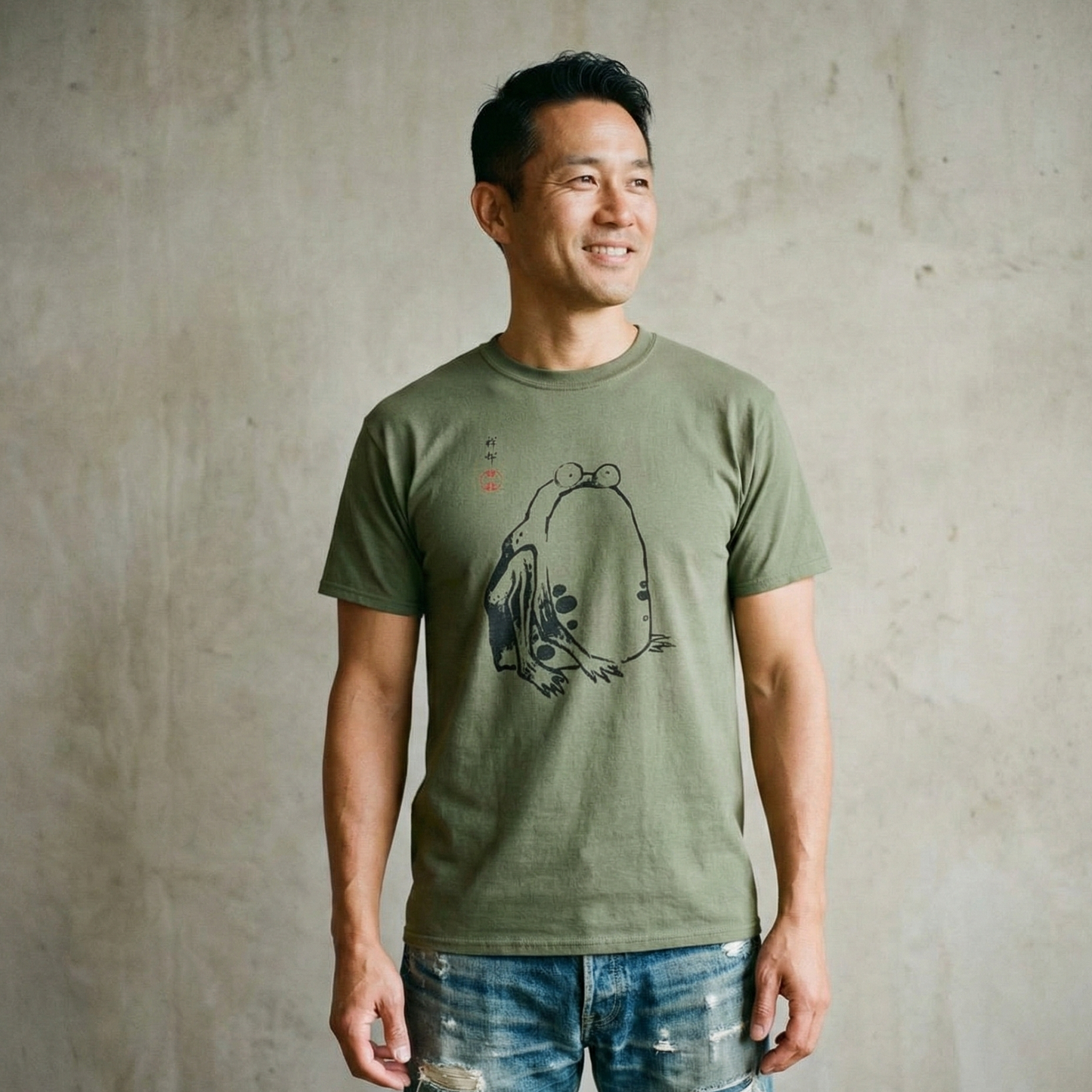 Man wearing a green t-shirt with a graphic design against a textured wall.